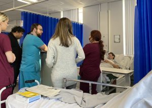 Physician Associate students being taught by academic on a medical scenario using an associate clinical educator in the role of a patient